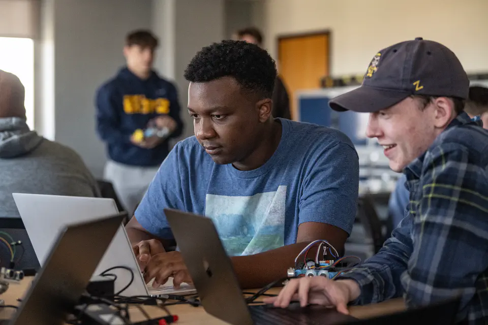 Students looking at a computer